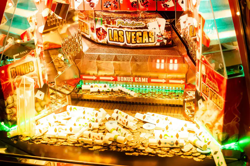 Glowing coin slots on a vintage upright arcade cabinet