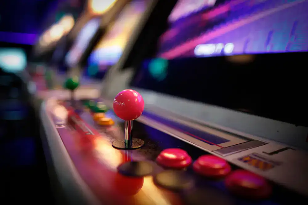 Close up of a milkshake and soda on a vintage arcade cabinet glass
