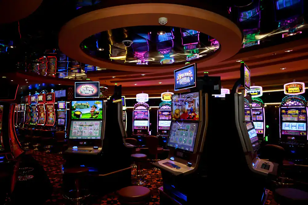 Wide view of the arcade floor with rows of classic machines